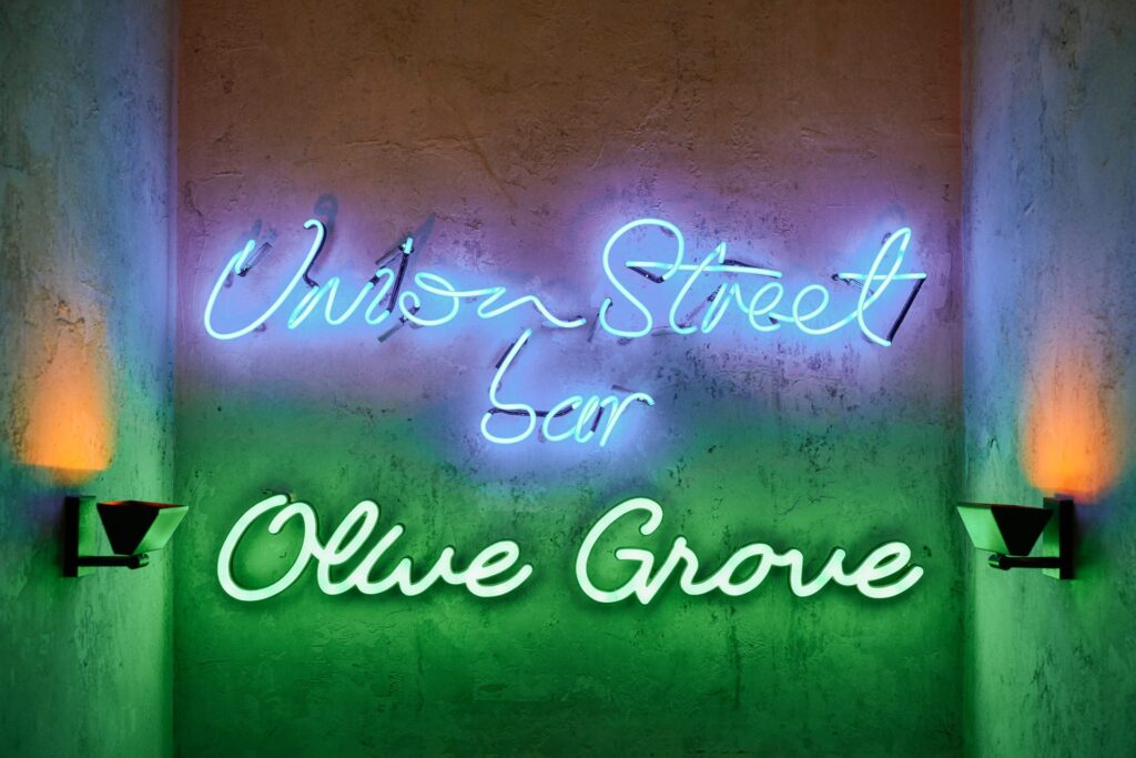 Lit up neon sign saying Union Street Café Olive Grove