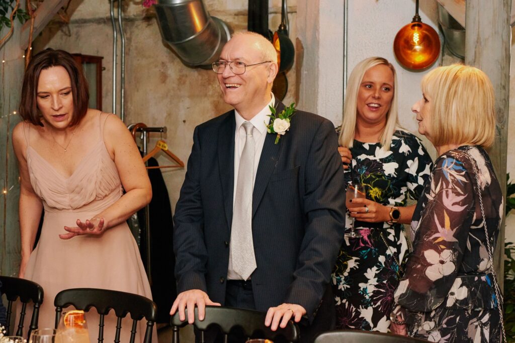 Happy wedding guest laughing in the Olive Grove at Union Street Café 