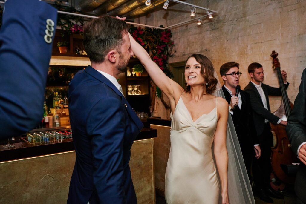 Happy bride & groom dancing during their first dance at Union Street Café wedding venue