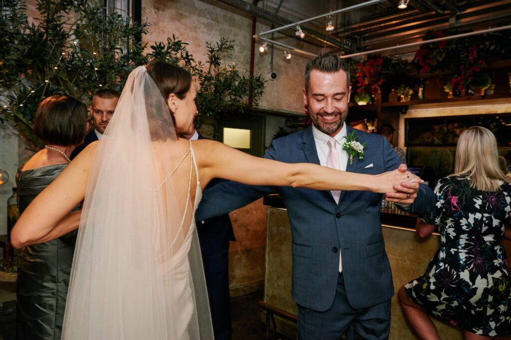 Bride dancing with the best man during her wedding at the Olive Grove, Union Street Café.
