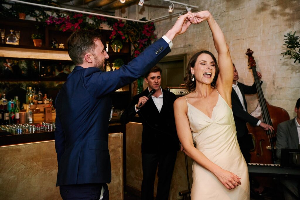 Happy bride & groom dancing during their first dance at Union Street Café wedding venue