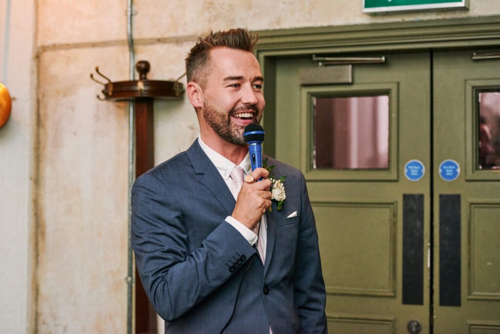 Best man giving a speech during a wedding at the Olive Grove, Union Street Café.