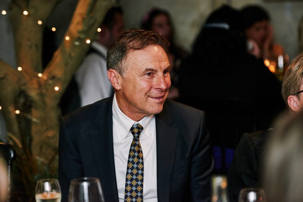 Wedding guest smiling during Italian themed wedding breakfast