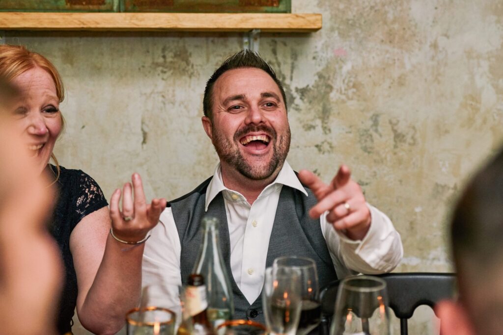 wedding guests laughing during small wedding reception at Union Street Café.