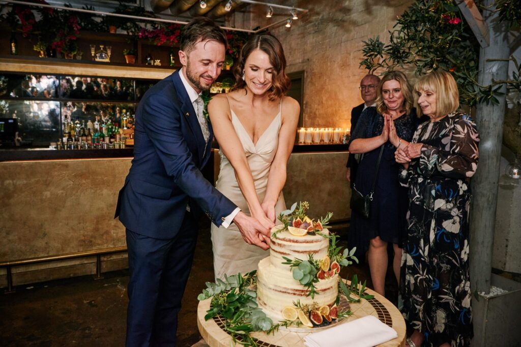 bride & groom cutting their wedding cake during small wedding reception at Union Street Café.