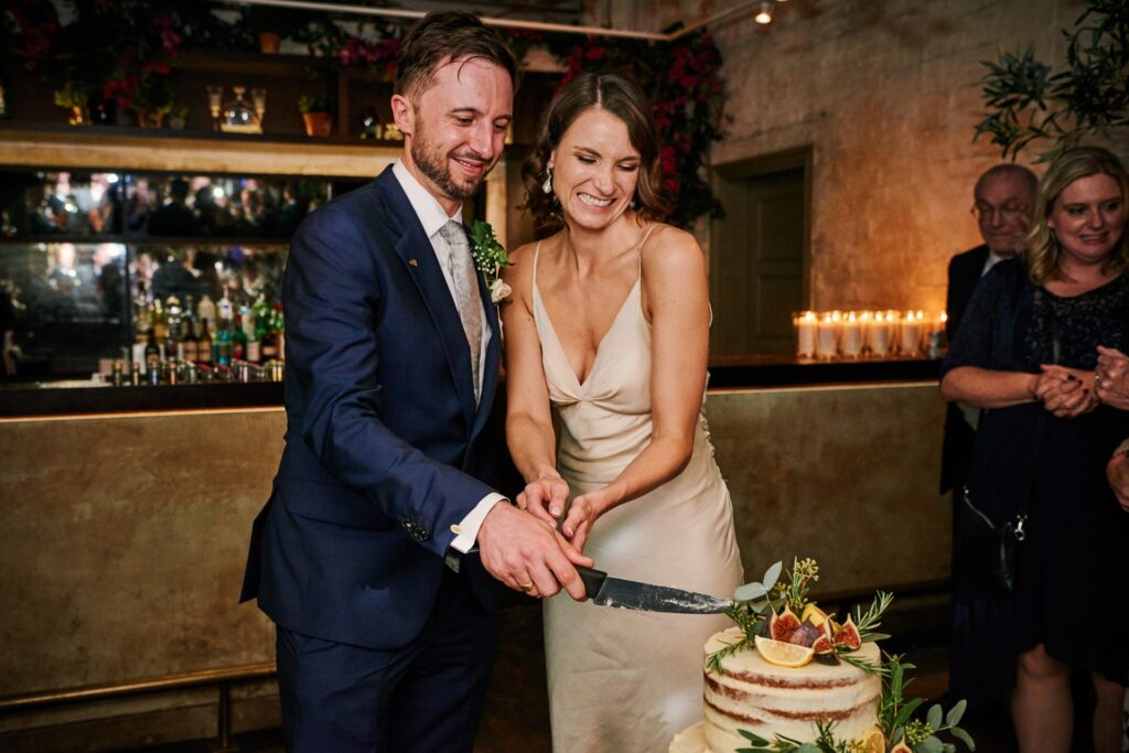 bride & groom cutting their wedding cake during Union Street Café wedding