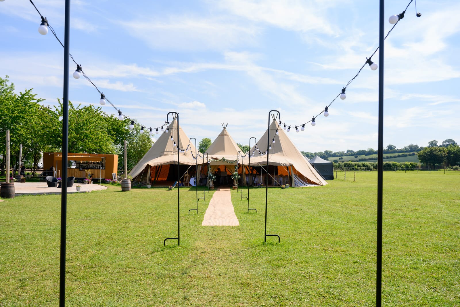 Exterior photo of Overgrown Acres tipi surrounded by green meadows in Nottinghamshire