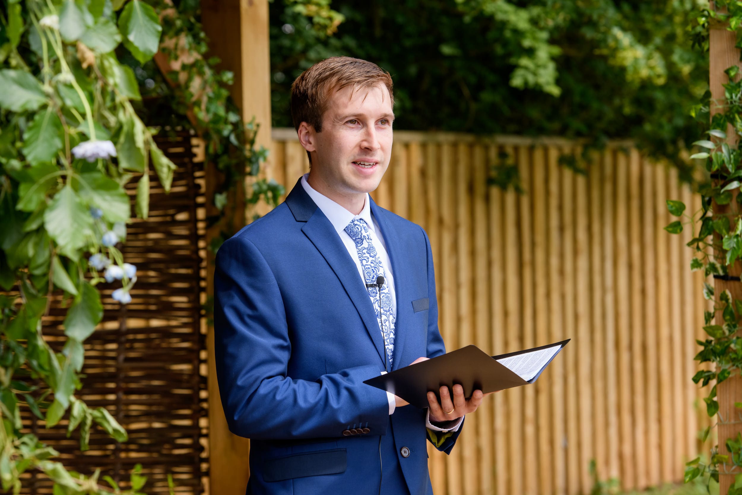 Overgrown acres officiant conducting outdoor wedding ceremony in Nottingham