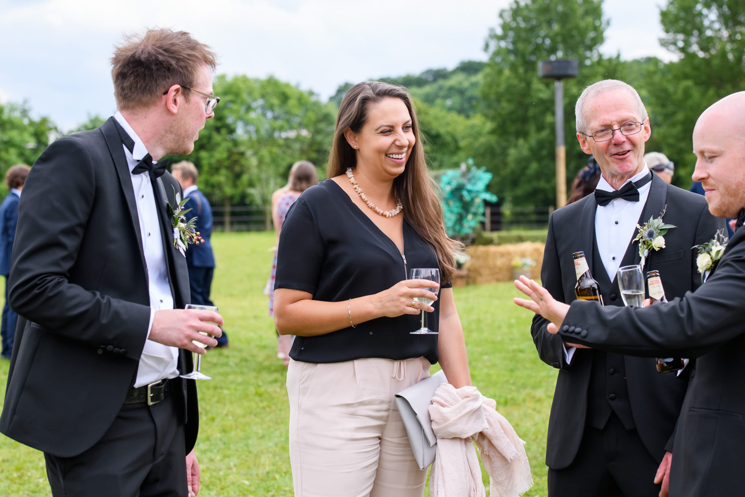 female wedding guests laughing and having fun during outdoor festival wedding