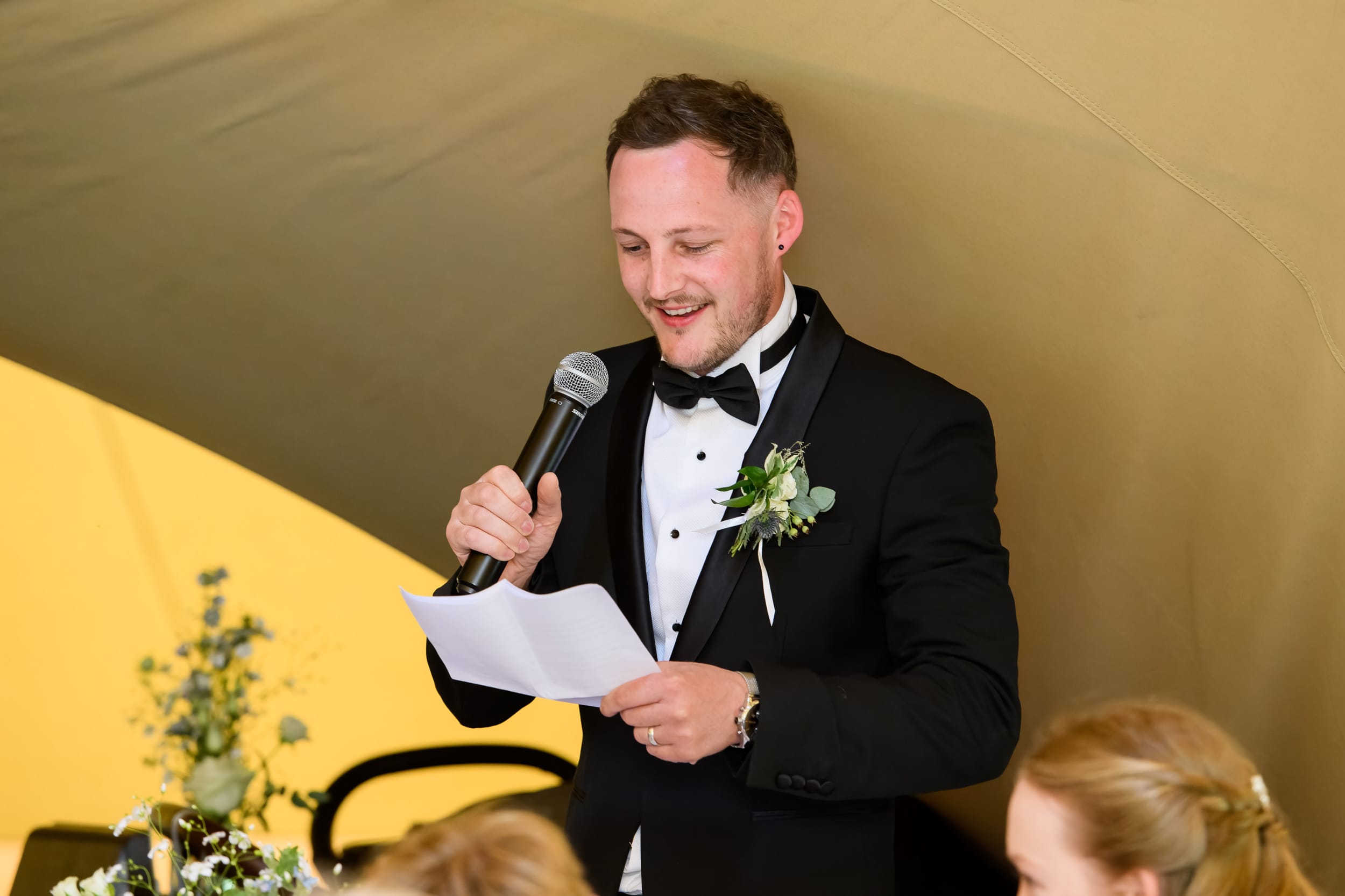 Best man giving a speech whilst inside a festival tipi