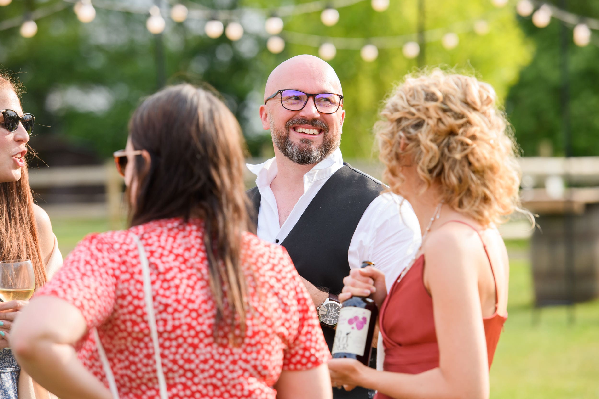 Candid photography featuring laughing wedding guest during festival wedding