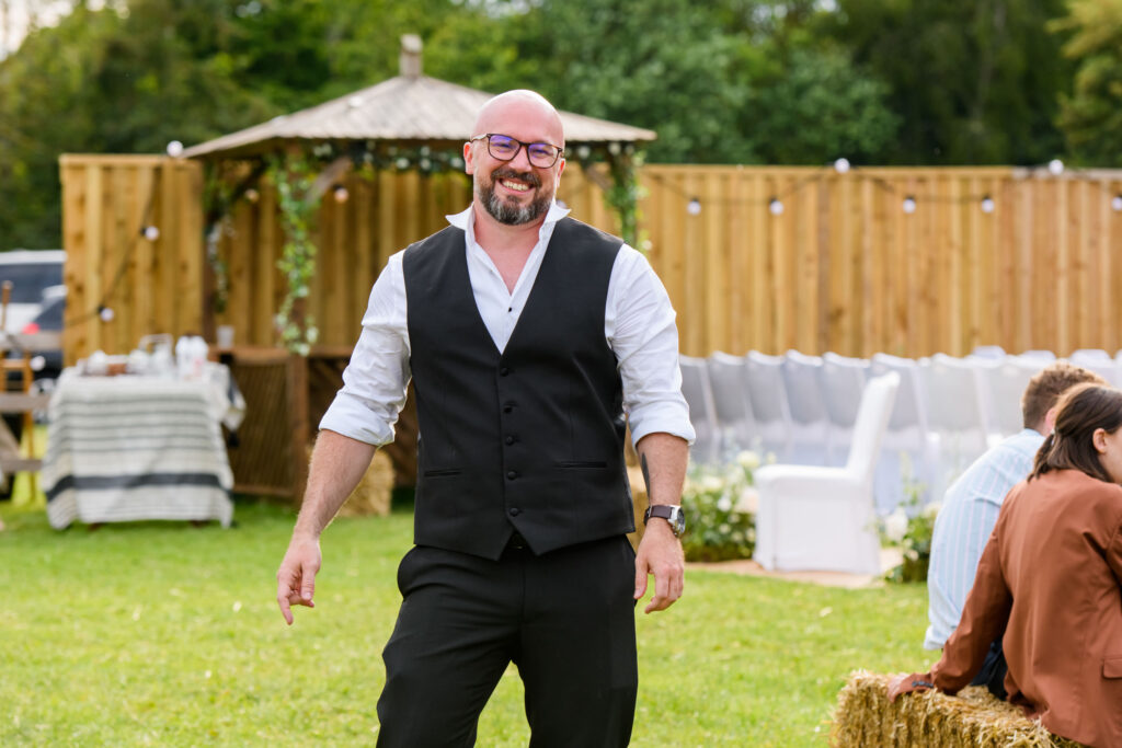 Wedding guest laughing during festival wedding in Nottinghamshire
