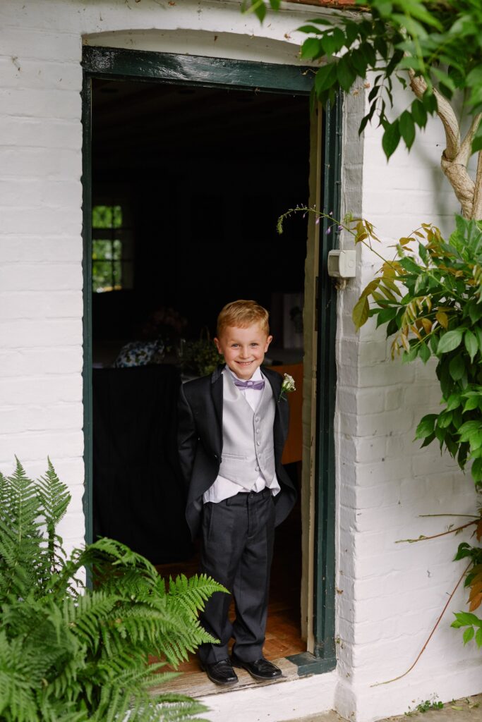young kid in the doorway of the farmhouse door at Ridge Farm