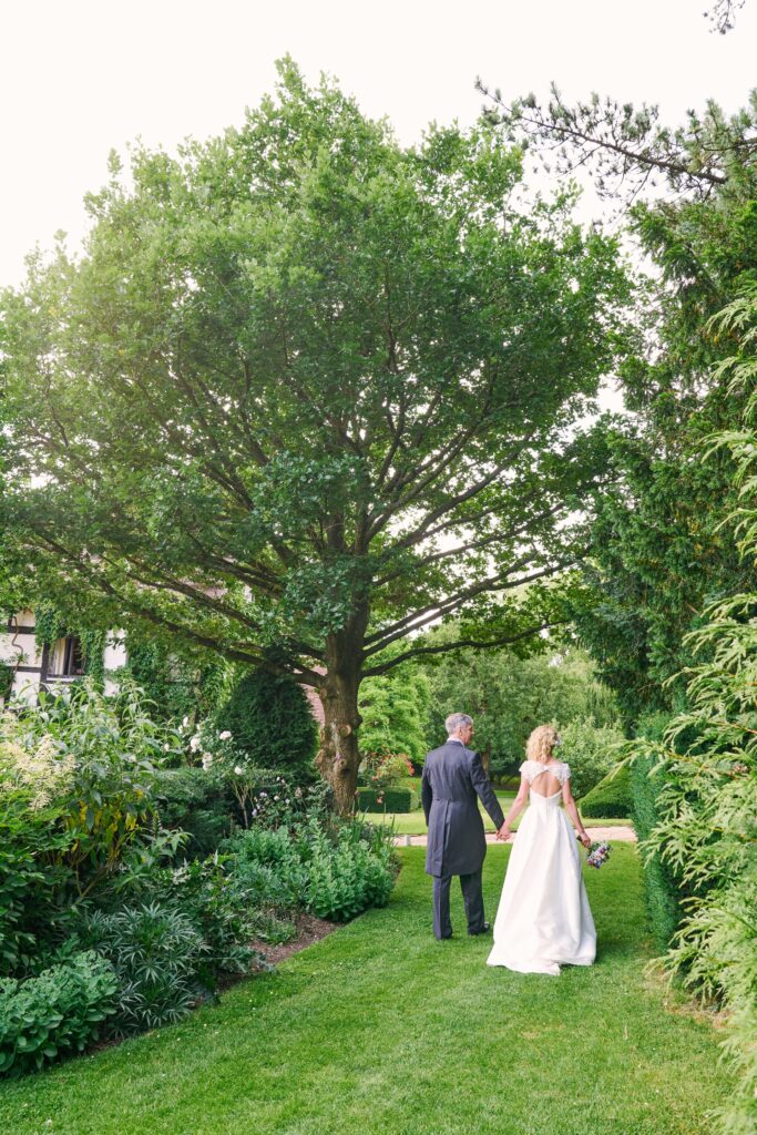 bride and groom walking though the grounds at Ridge Farm wedding venue
