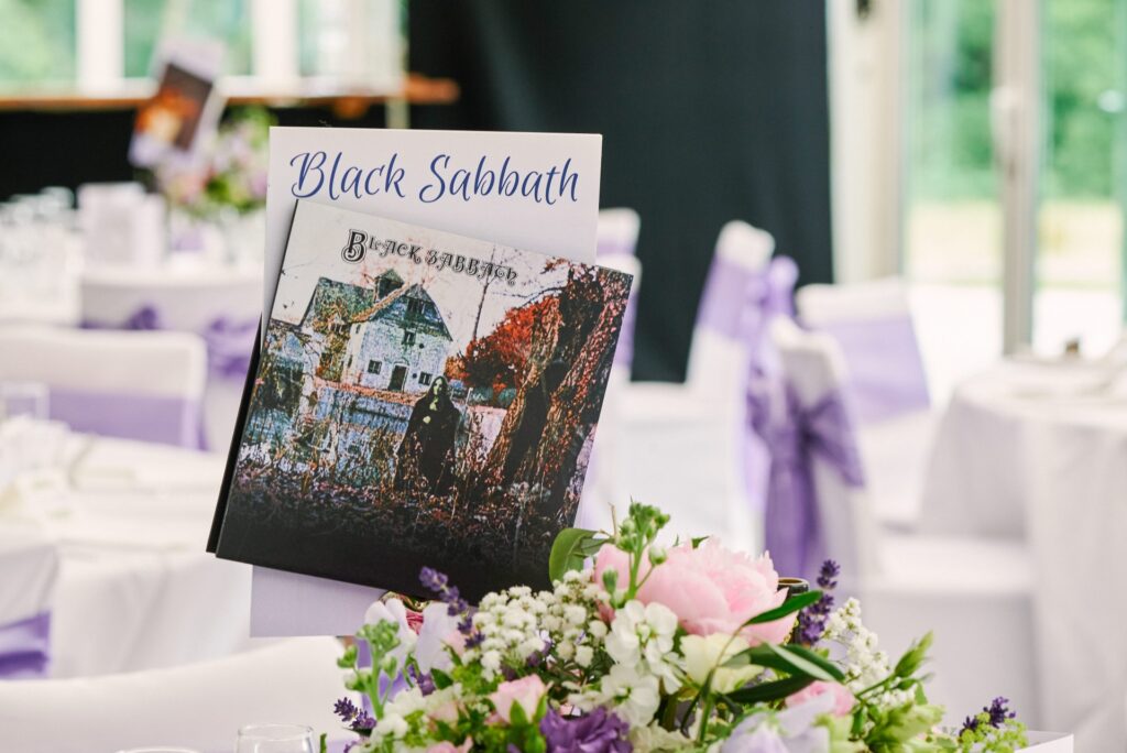 Black Sabbath themed wedding table with vinyl on top of flowers