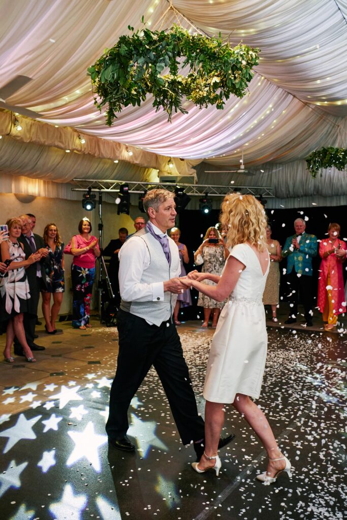 bride and groom during their first dance in the pool house
