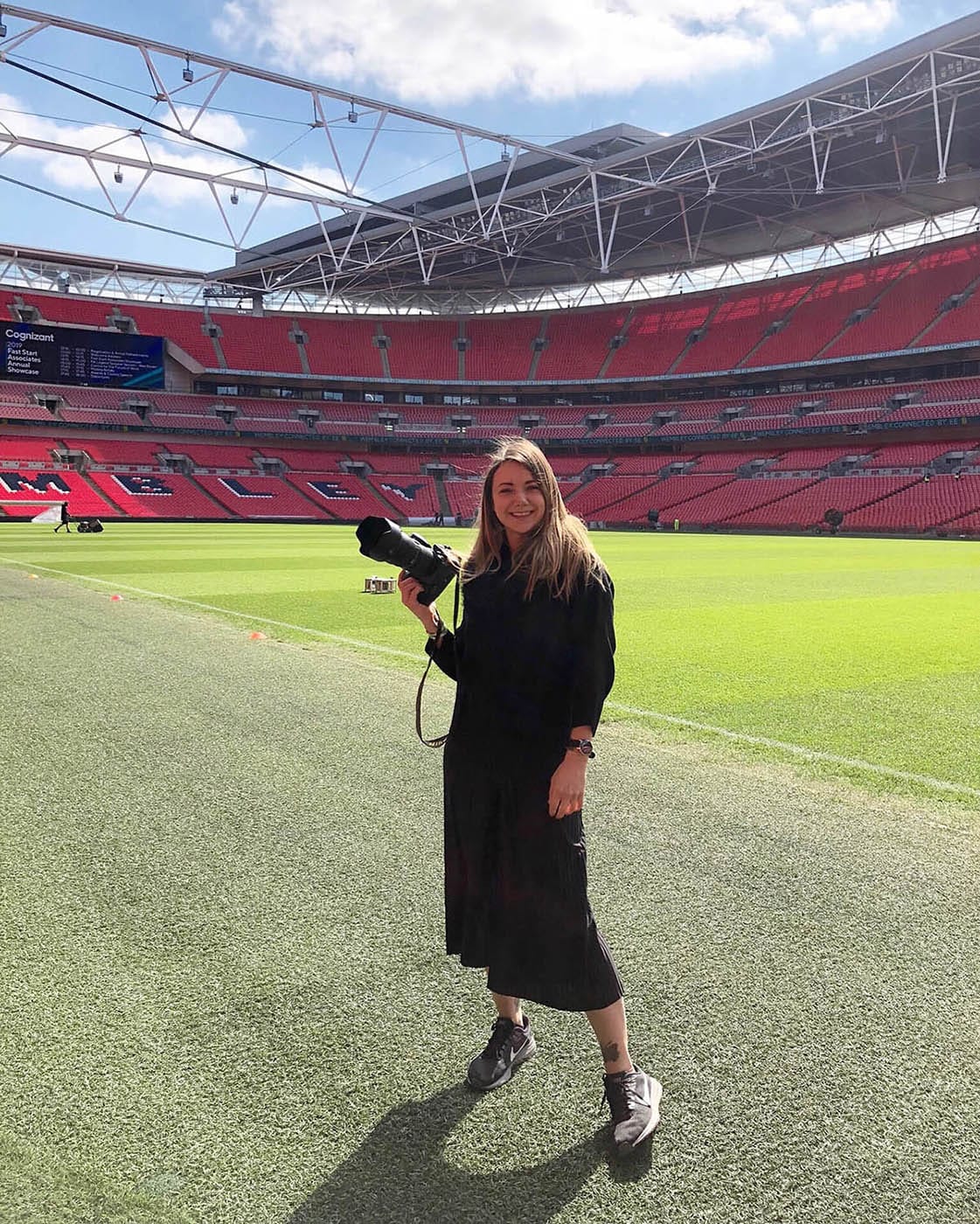 Sally Rose Photography Channel 4 Wembley Stadium Photo Shoot Photographer Sally Rose holding her camera in football stadium