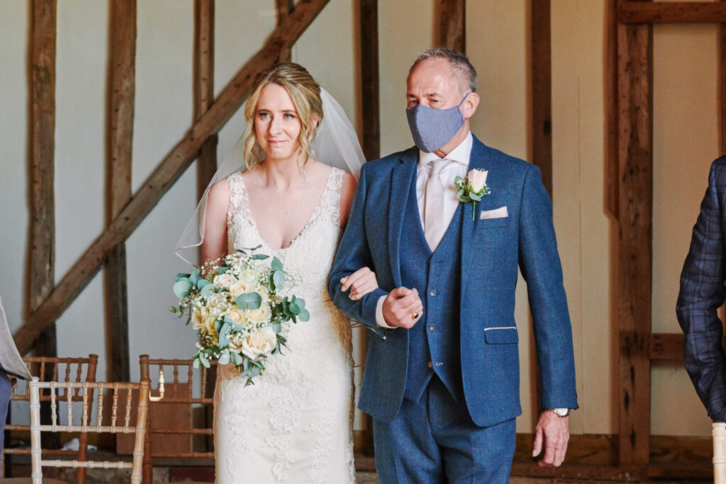 Bride & her dad walking down the aisle at stokes farm barn wedding venue