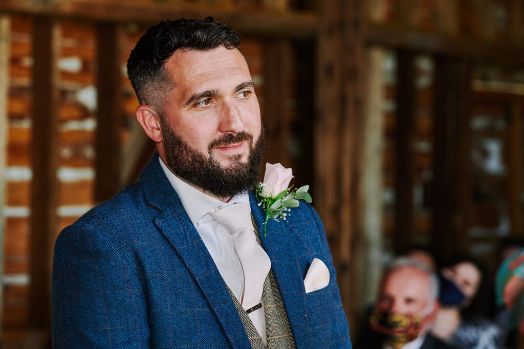 groom during his rustic wedding ceremony at stokes farm barn