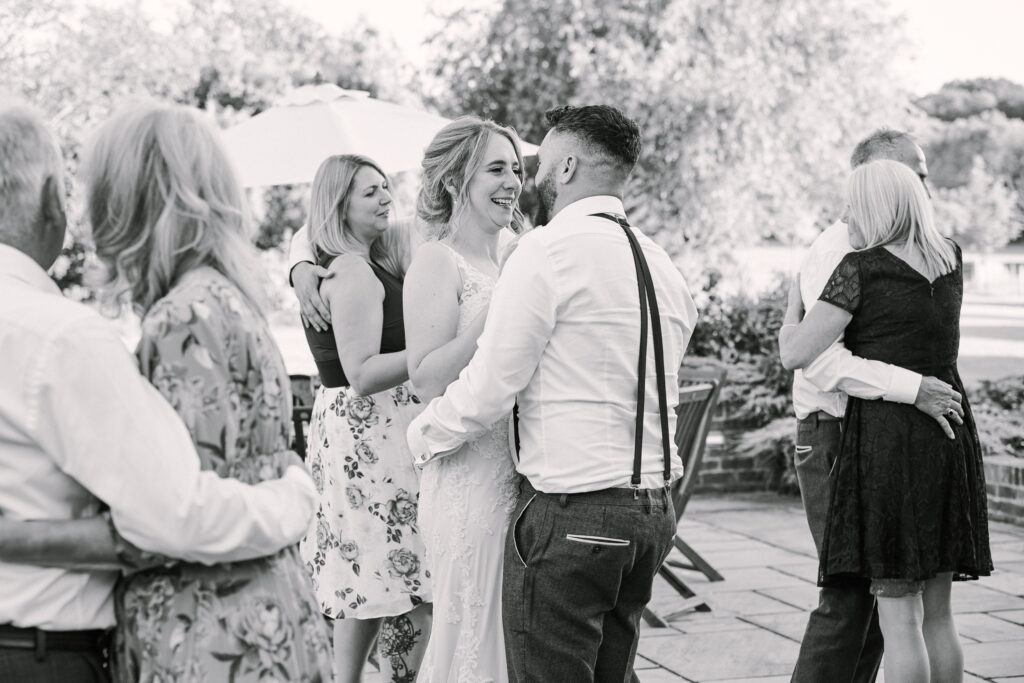 wedding photography showing bride and groom dancing together outside
