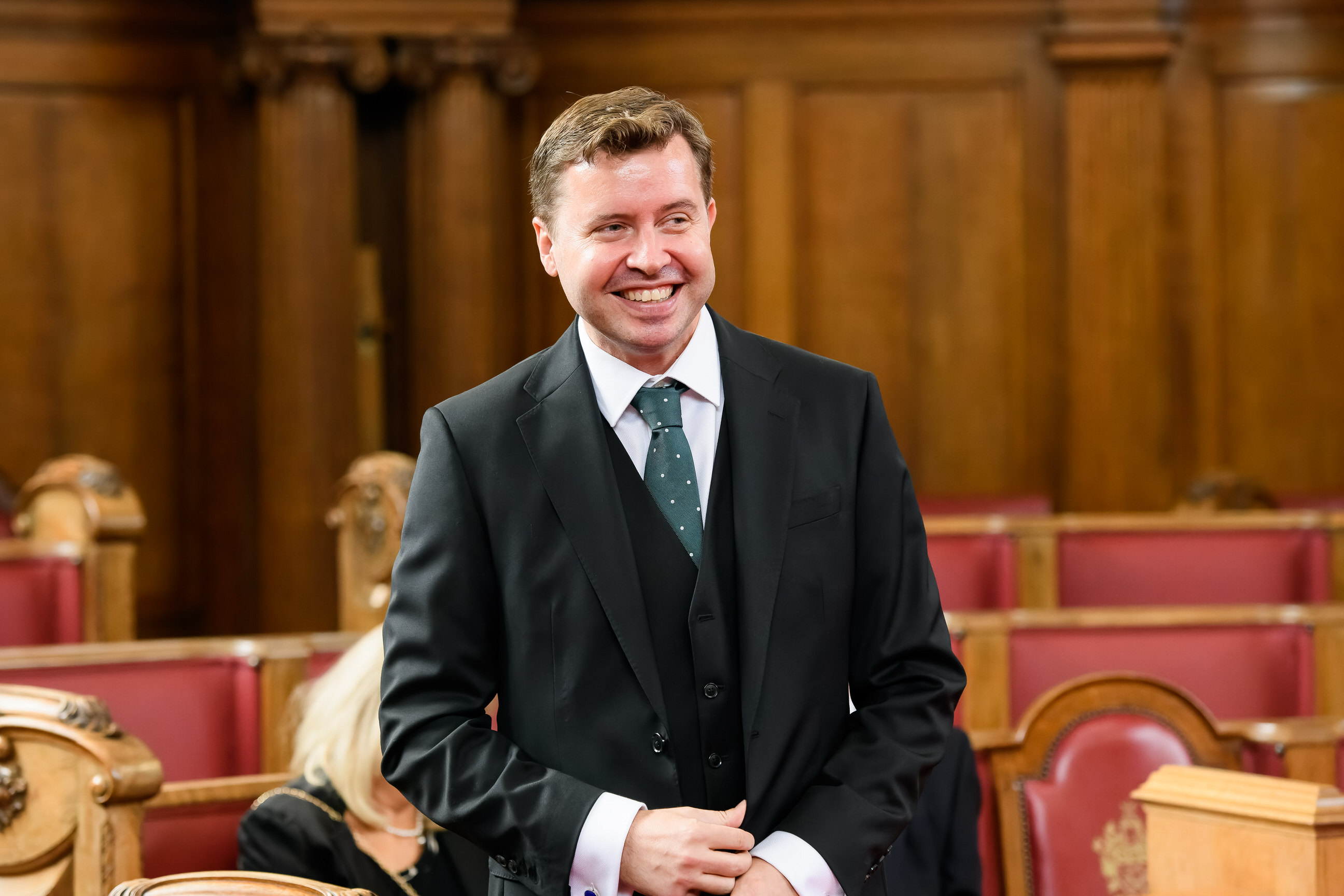 Groom laughing during Islington Town Hall Wedding in the Council Chamber