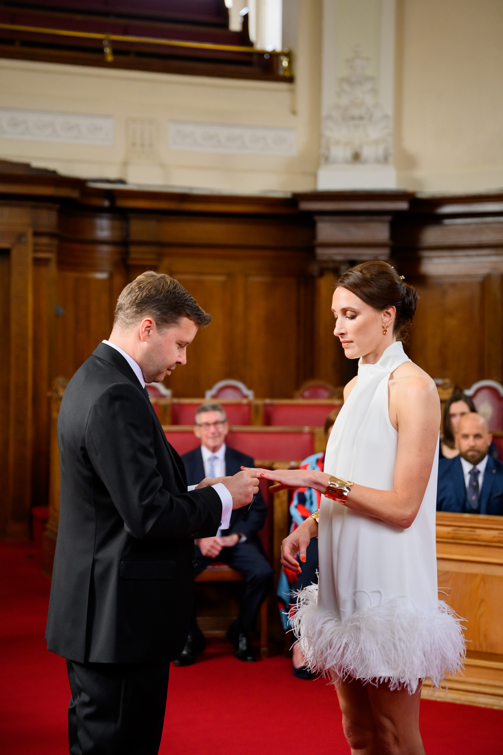 bride and groom exchanging rings during Islington Town Hall wedding ceremony