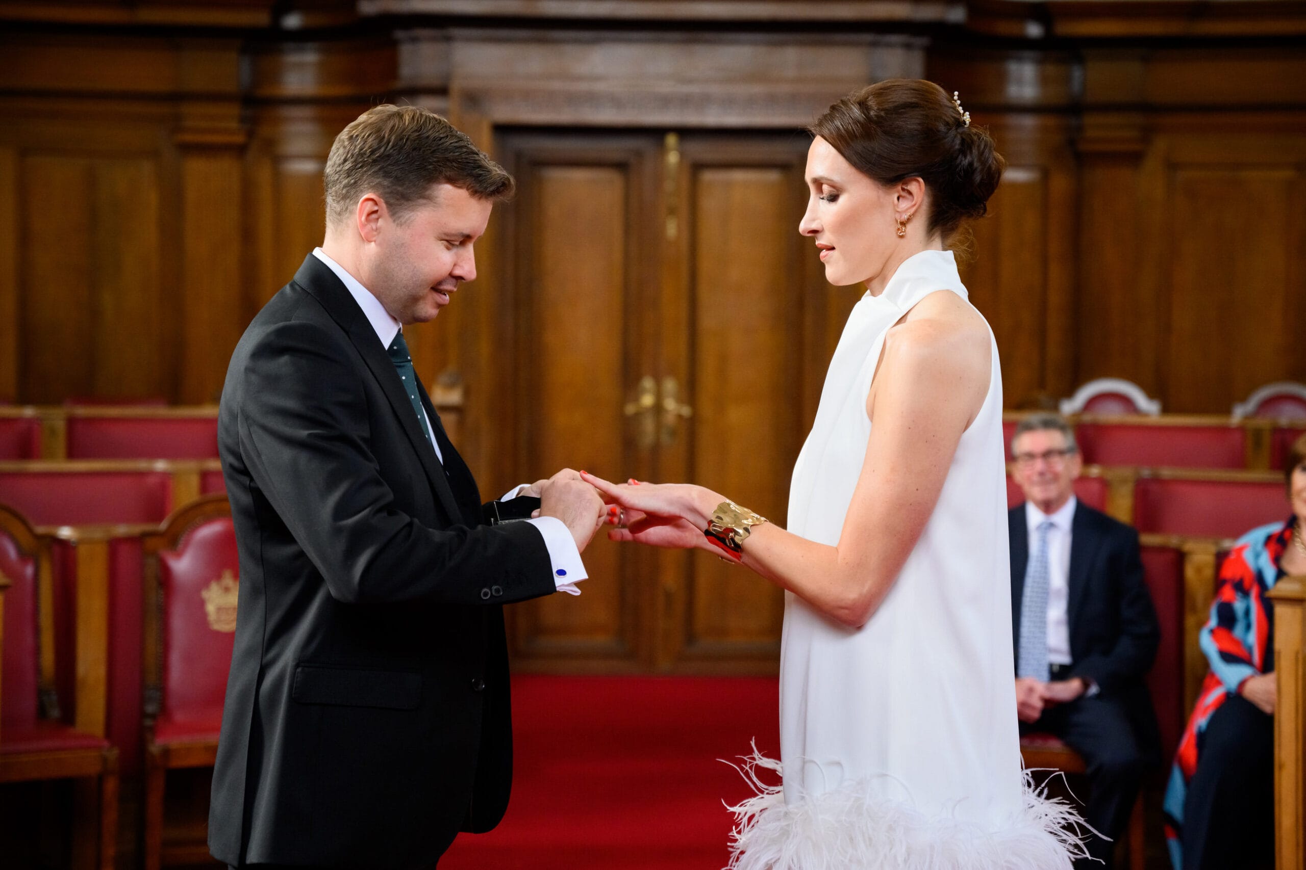 bride and groom exchanging rings during Islington Town Hall wedding ceremony