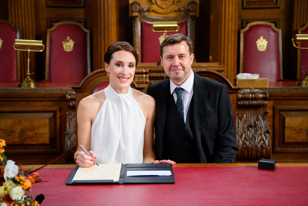 bride and groom singing the register during Islington Town Hall wedding
