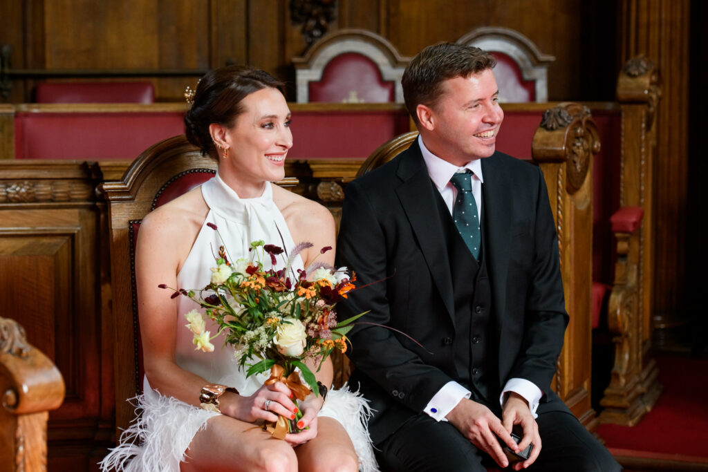 wedding couple sat down during Islington Town Hall wedding ceremony