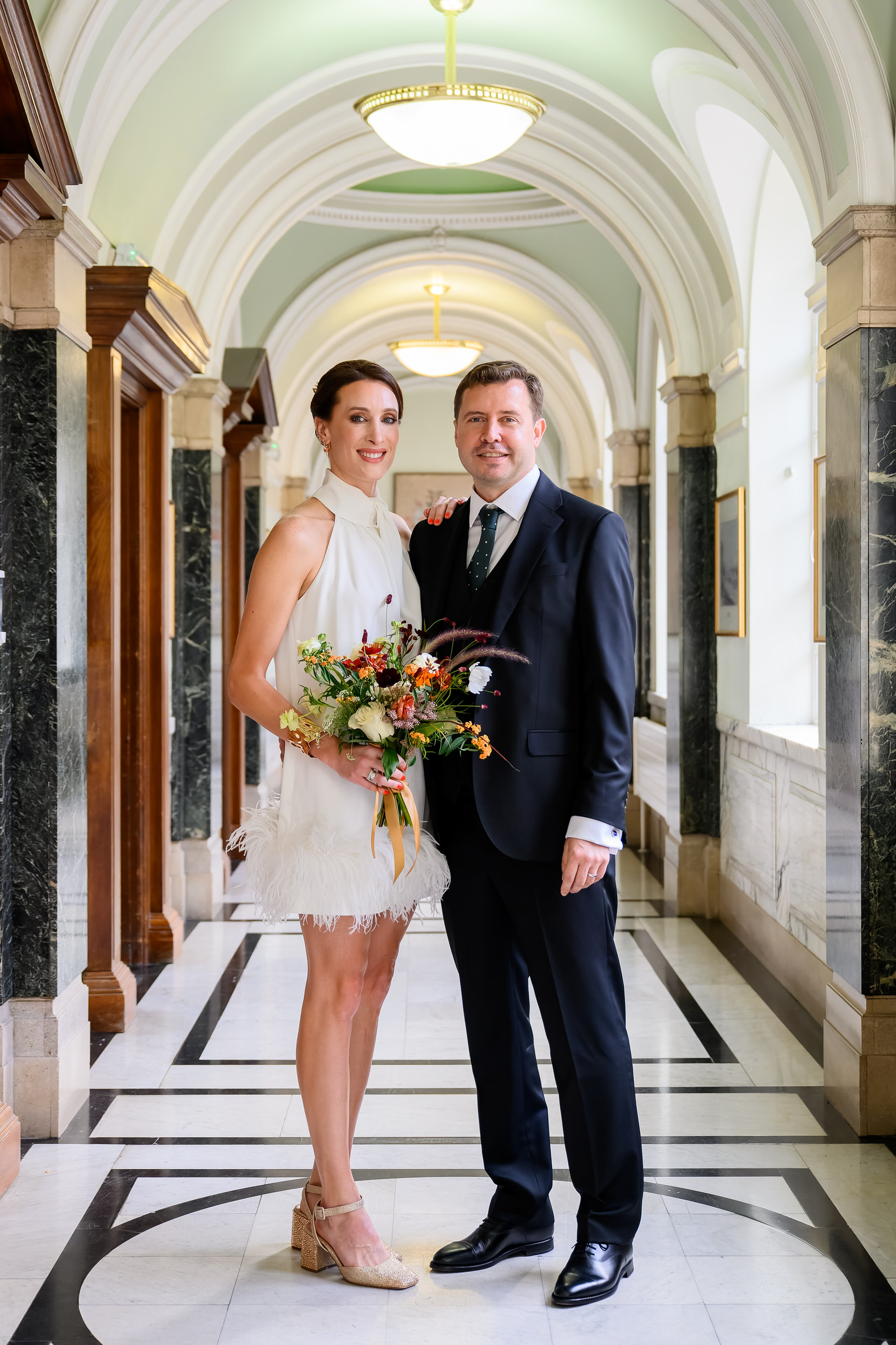Bride and groom smiling for the camera at Islington Town Hall wedding