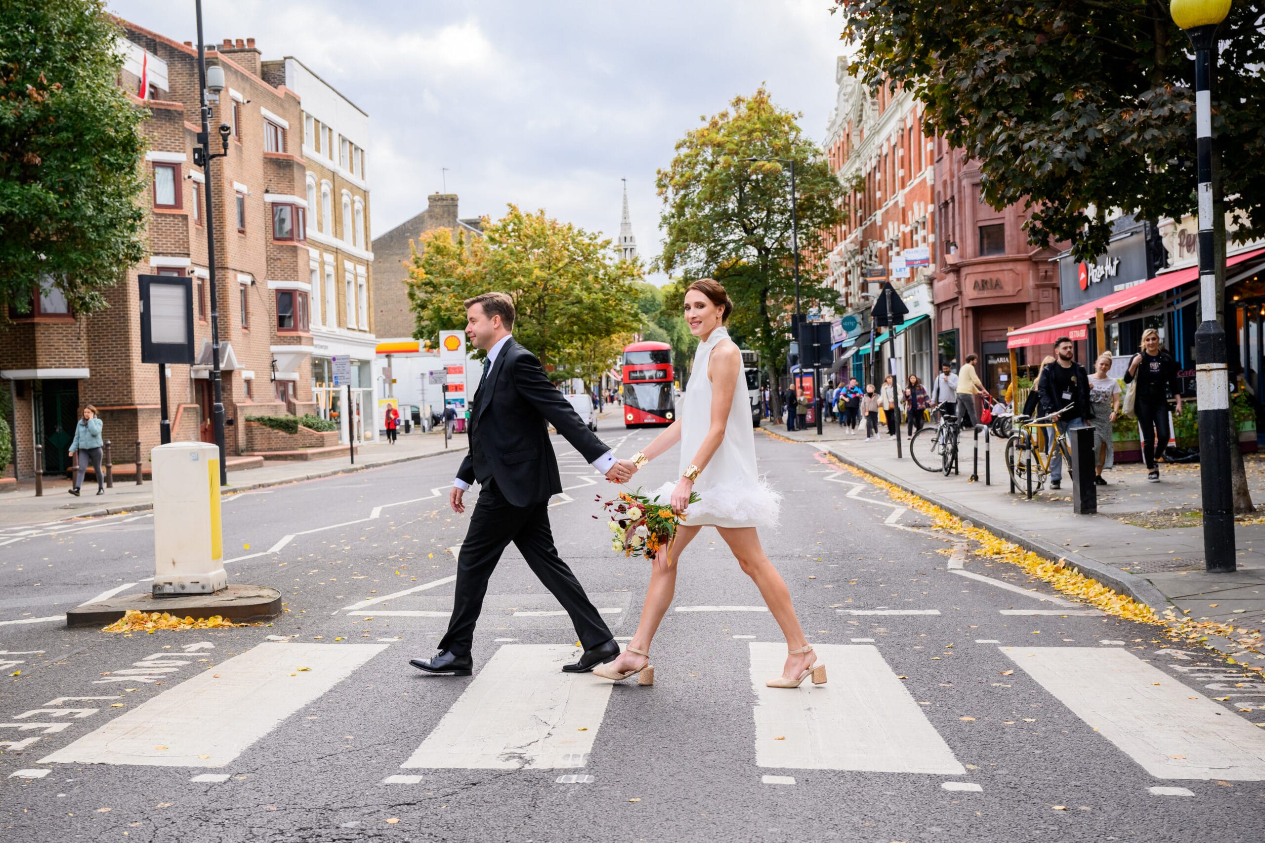 Islington Town Hall Wedding Photography bride and groom walking across zebra crossing on their to Islington Town Hall Wedding
