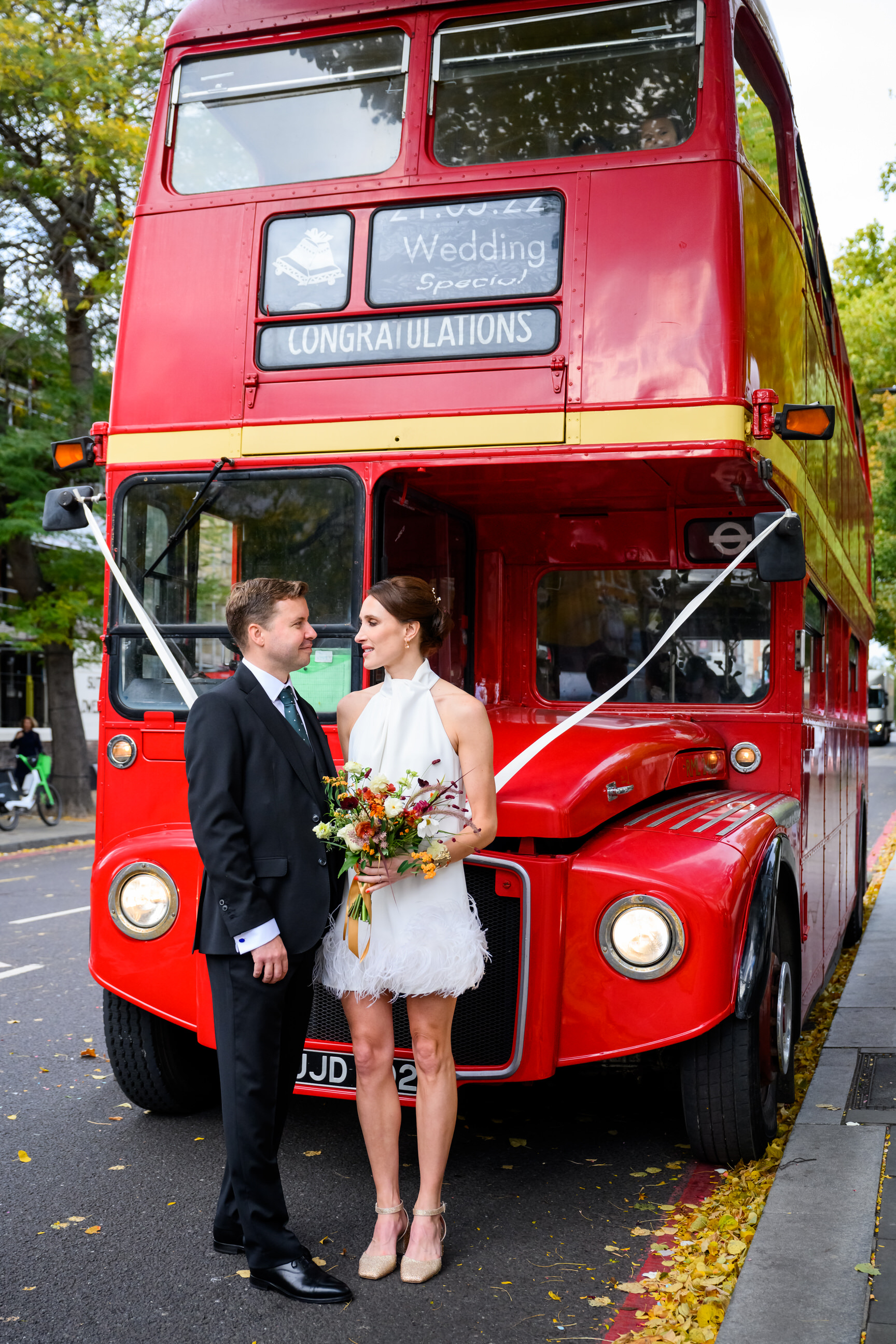 cool wedding couple in front of London red bus outside Islington Town Hall