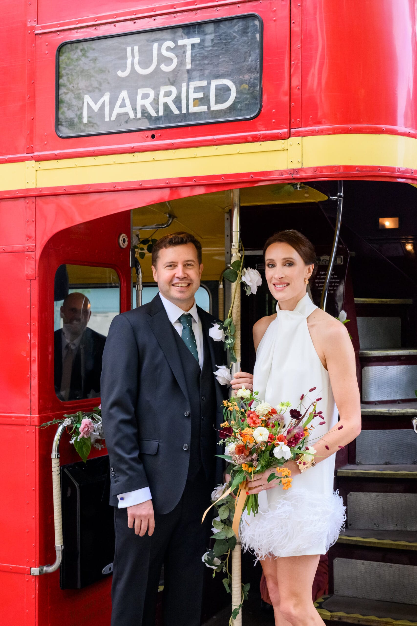 bride and groom in front of Red london route master bus outside Islington Town Hall