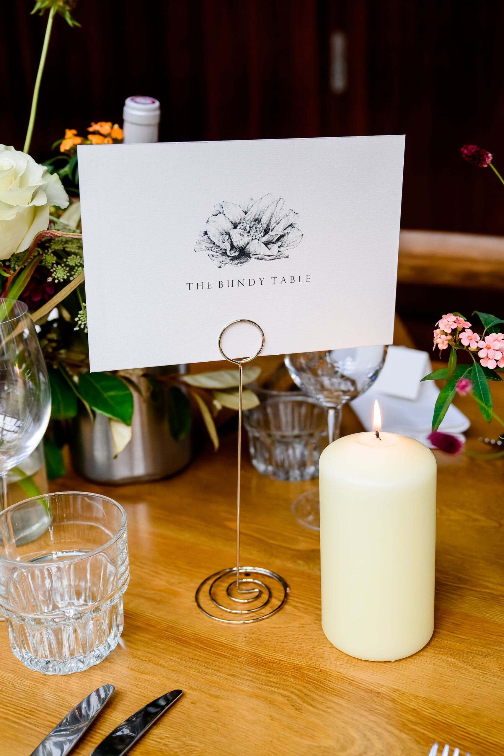Serial killer themed wedding table name in front of candle