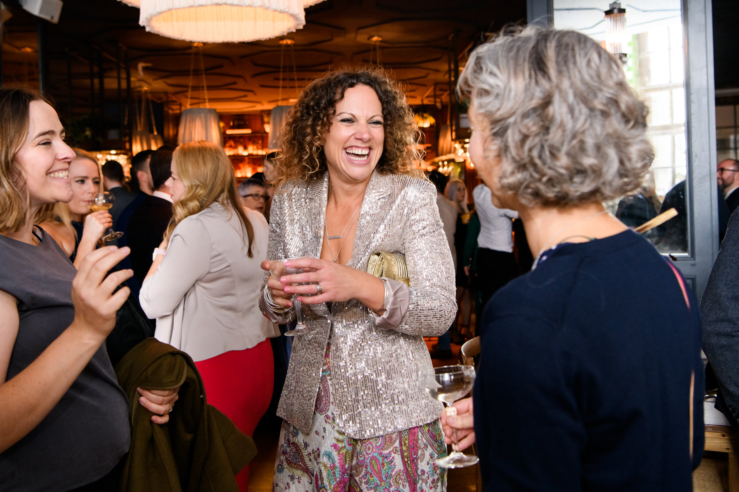 Candid photography of wedding guest laughing at The Singer Tavern Wedding Venue