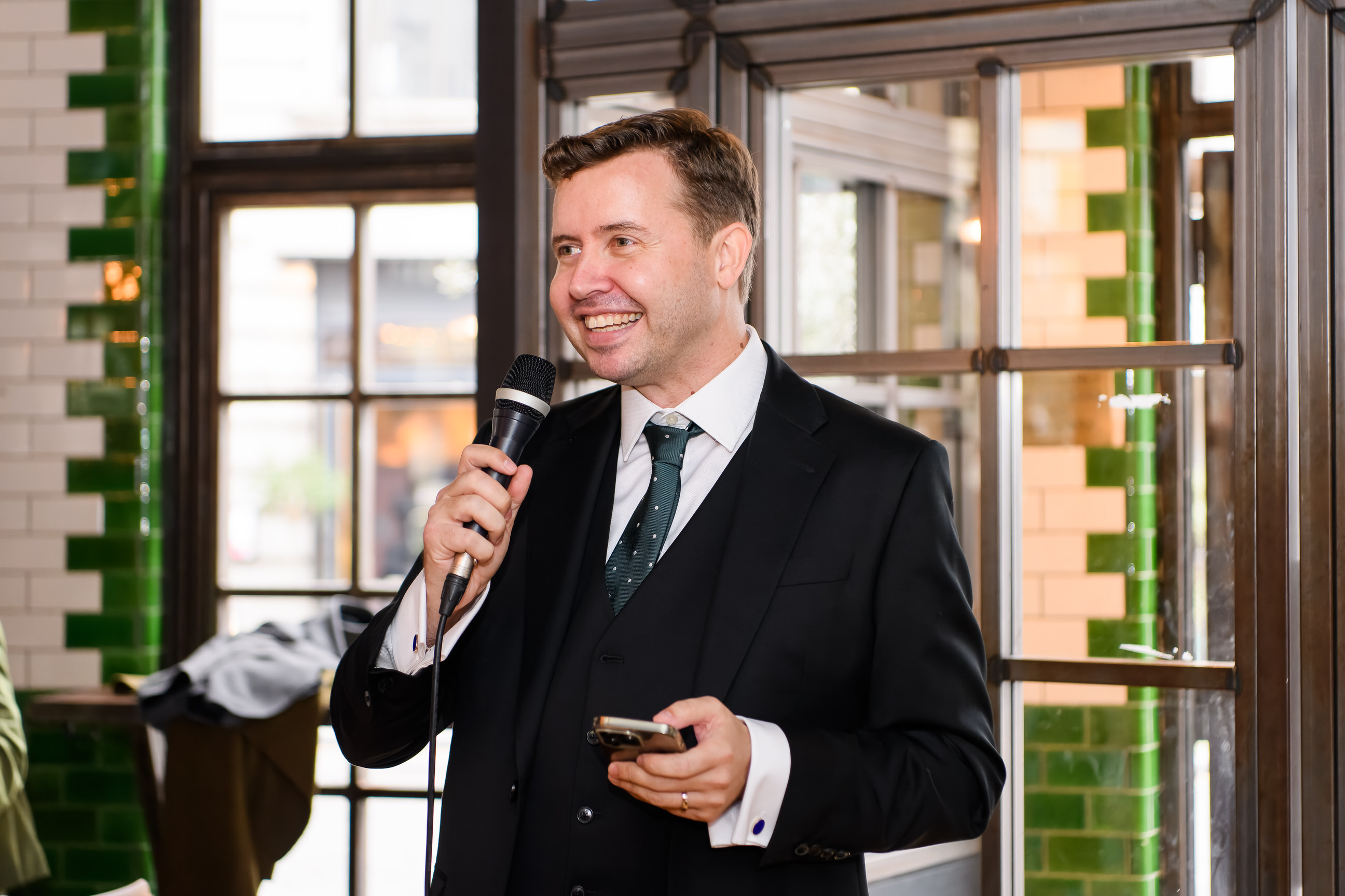 Groom smiling whilst giving a speech at The Singer Tavern Wedding Venue