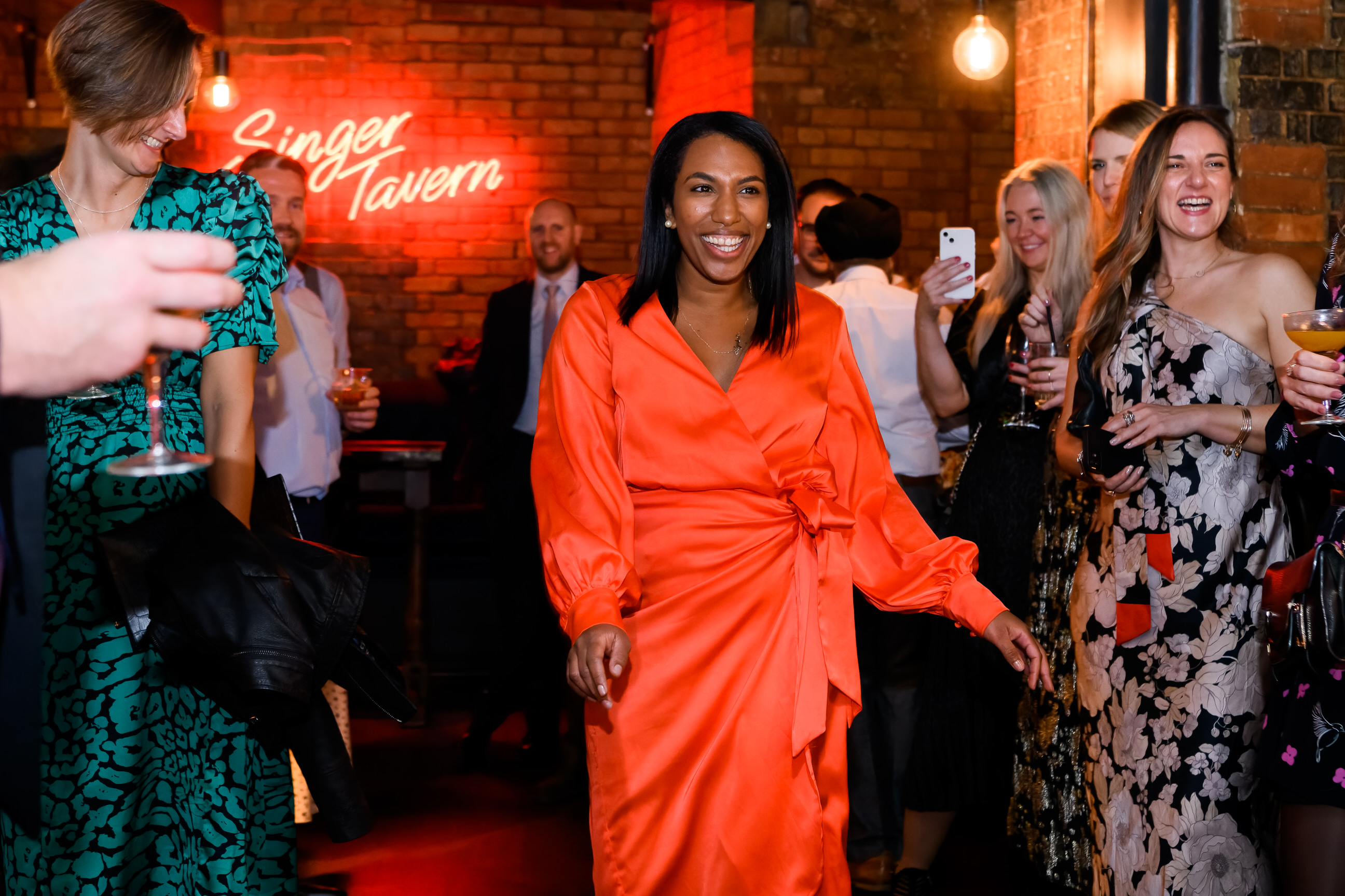 Happy wedding guest dancing in the Singer Tavern Basement