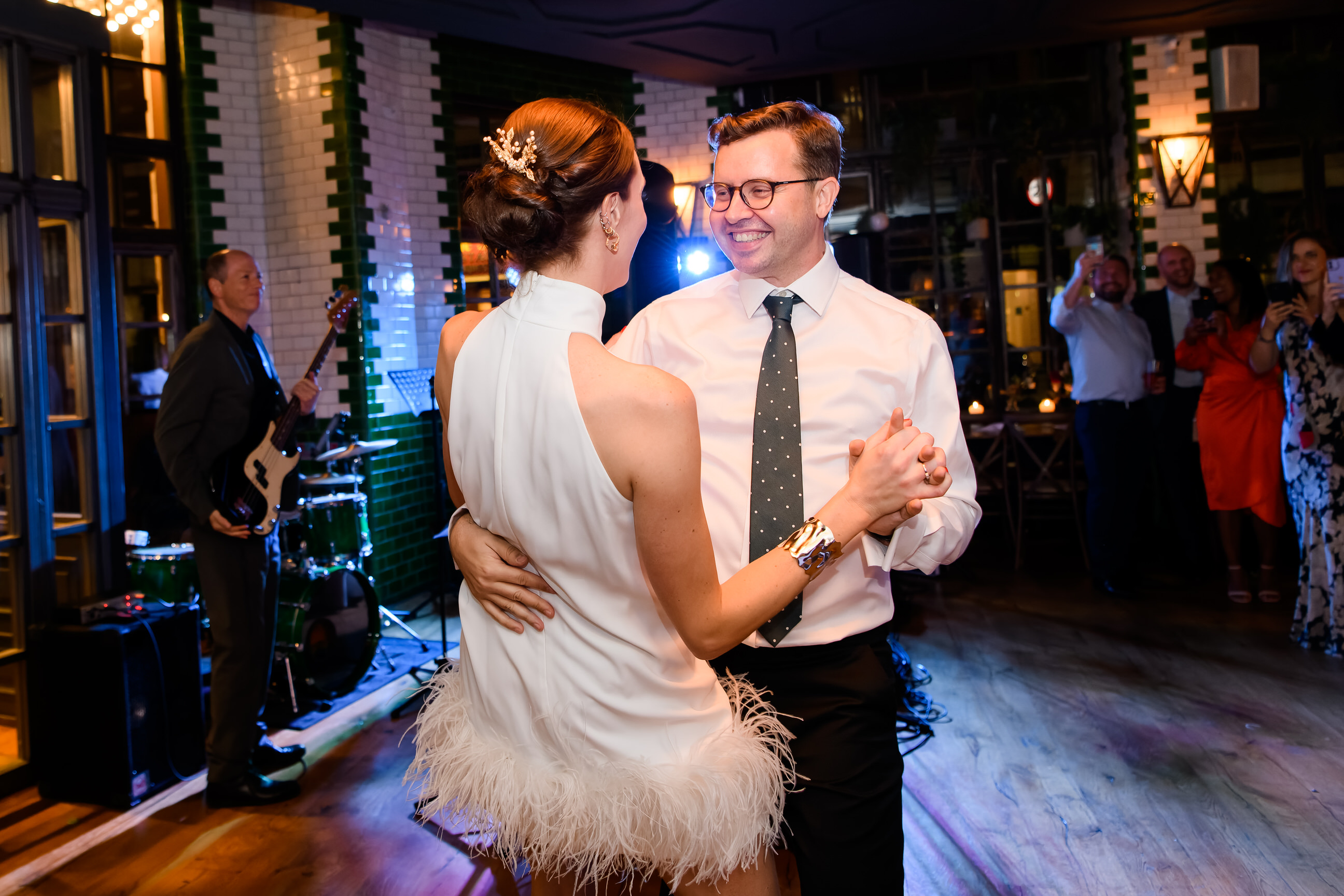 Happy bride and groom dancing together during fun London pub wedding