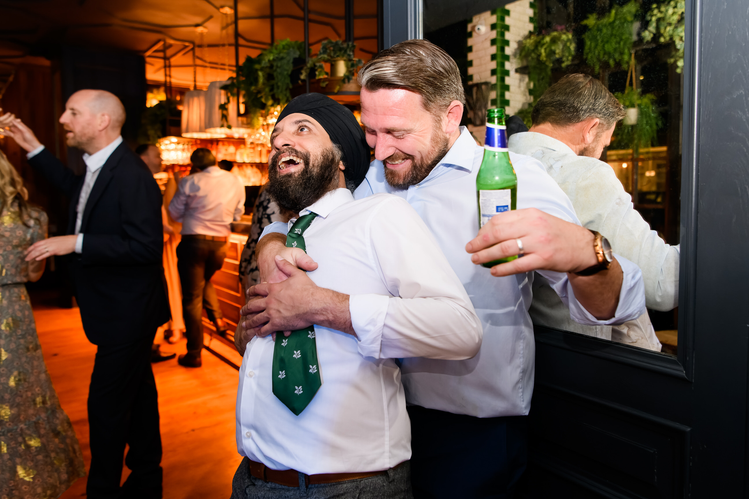 wedding guests dancing together during fun London pub wedding