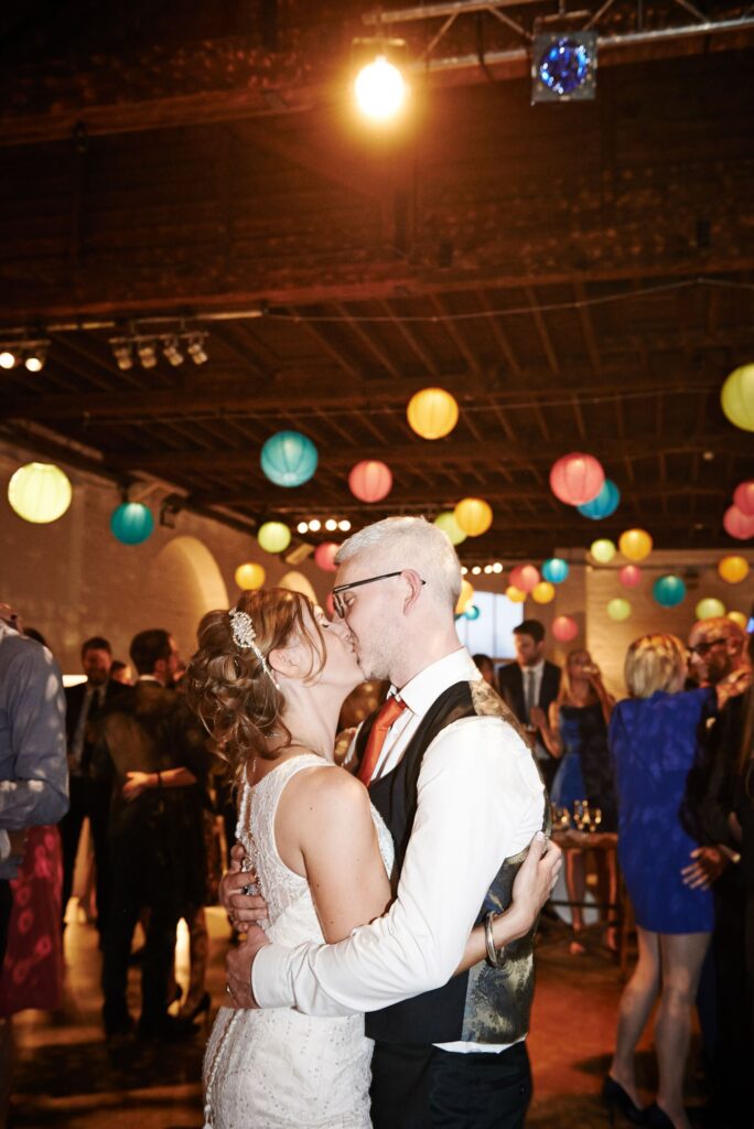 Wedding couple kissing during reception at Trinty Bouy Wharf Warehouse Wedding Venue