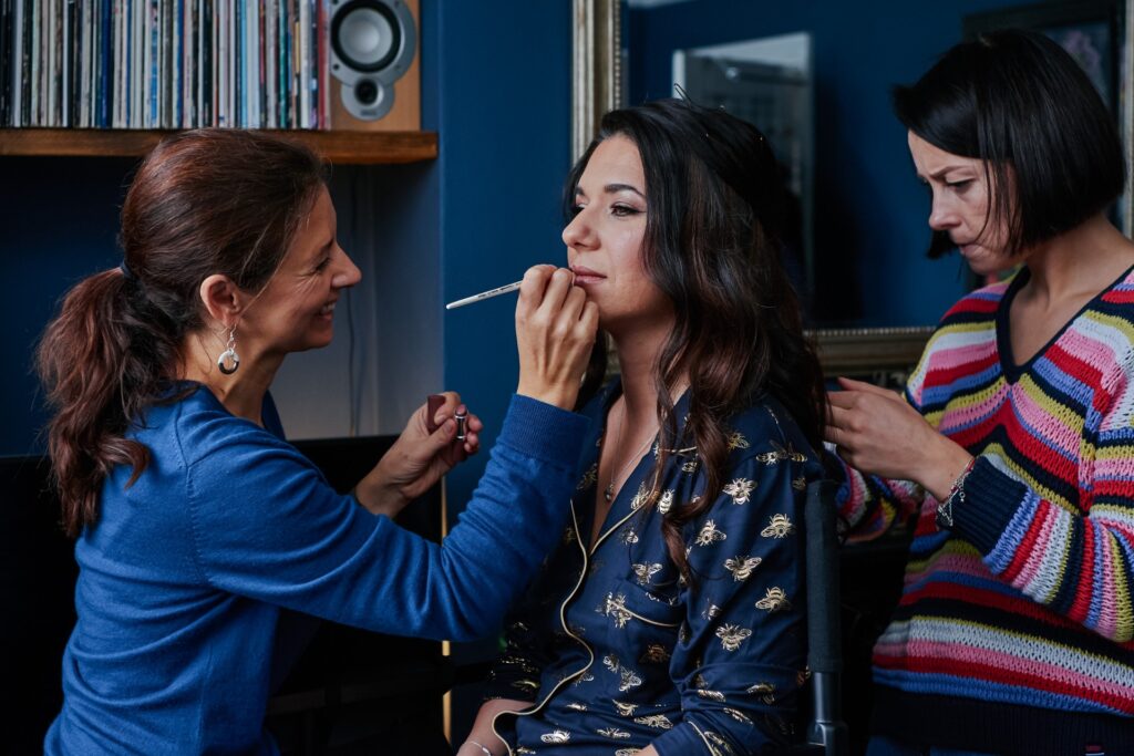 Bride having her makeup and hair done before her wedding day