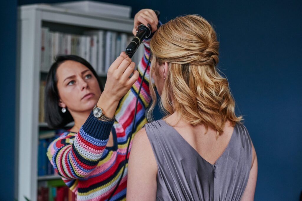 Bridesmiad having her hair done during bridal prep