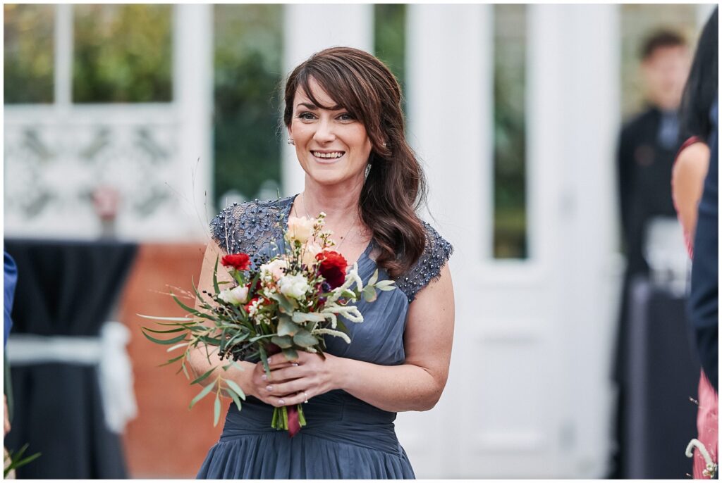 Bridesmaid walking down the aisle during winter wedding at The Horniman Museum