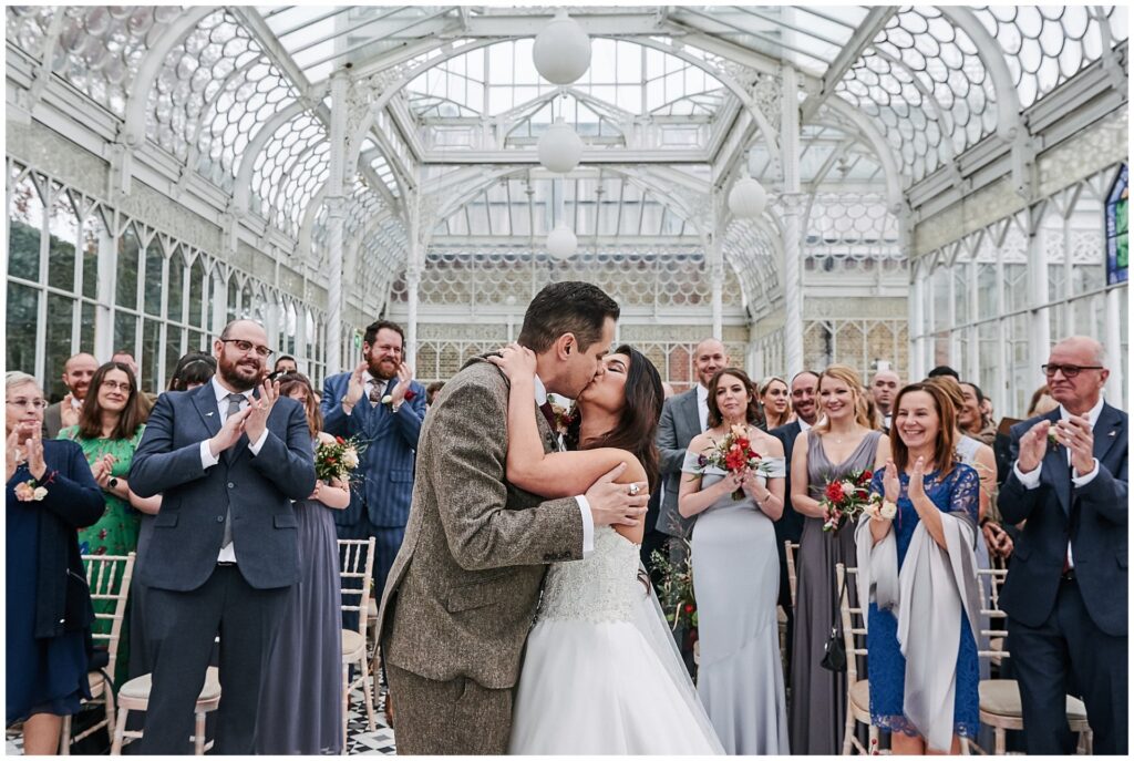 wedding couple kissing during ceremony at The Horniman Museum conservatory