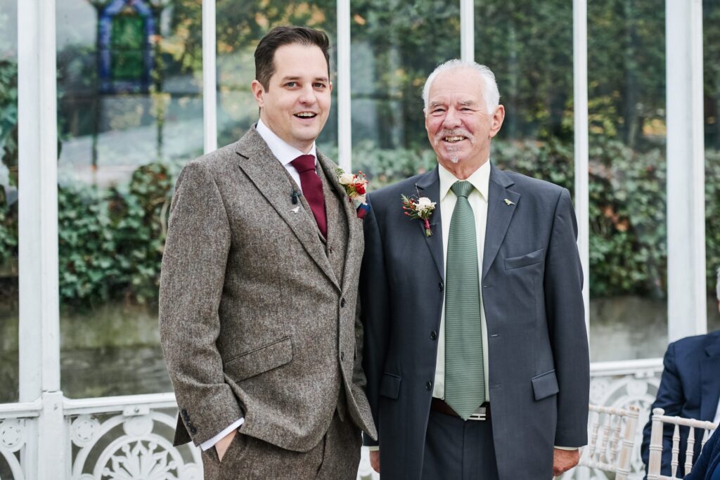 groom smiling with his day during wedding at The Horniman Museum conservatory