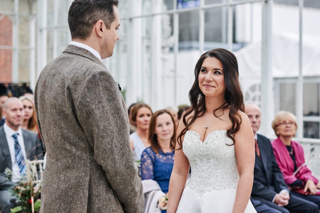bride and groom during their wedding ceremony at The Horniman Museum conservatory