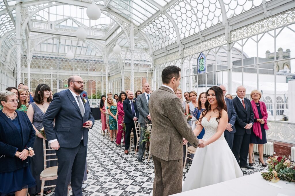 bride and groom during their wedding ceremony at The Horniman Museum conservatory