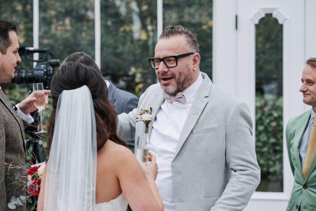 wedding guests socialising in the  conservatory at The Horniman Museum 