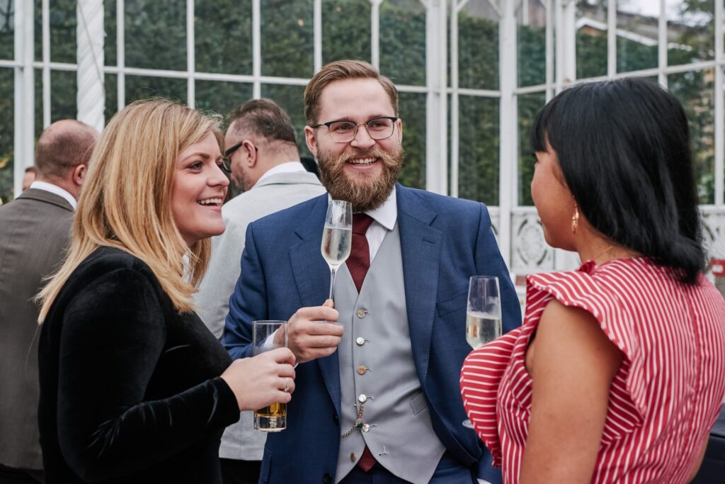 wedding guests socialising in the  conservatory at The Horniman Museum 