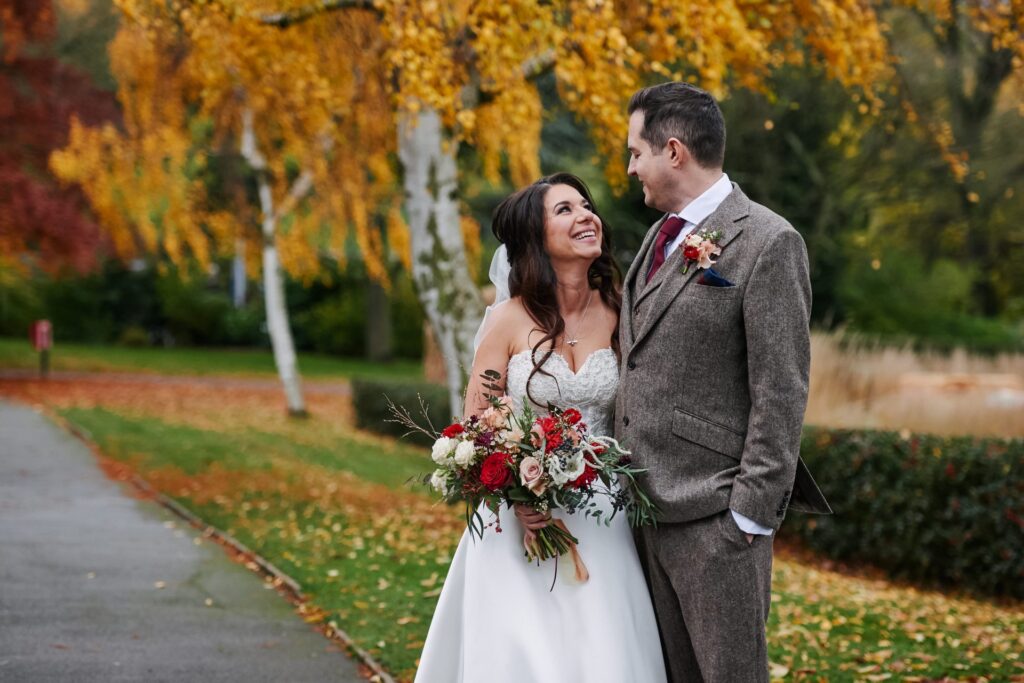 Bride and groom smiling together in the gardens at The Horniman Museum